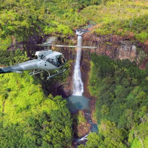 Helicopter flying doors off over Kauai lush landscape