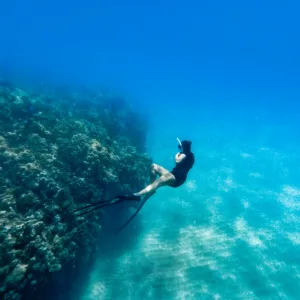 Snorkelers exploring vibrant coral reefs in clear water