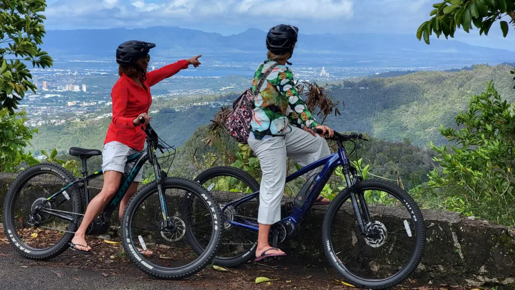 E-bike riders cycling through lush Honolulu rainforest trails