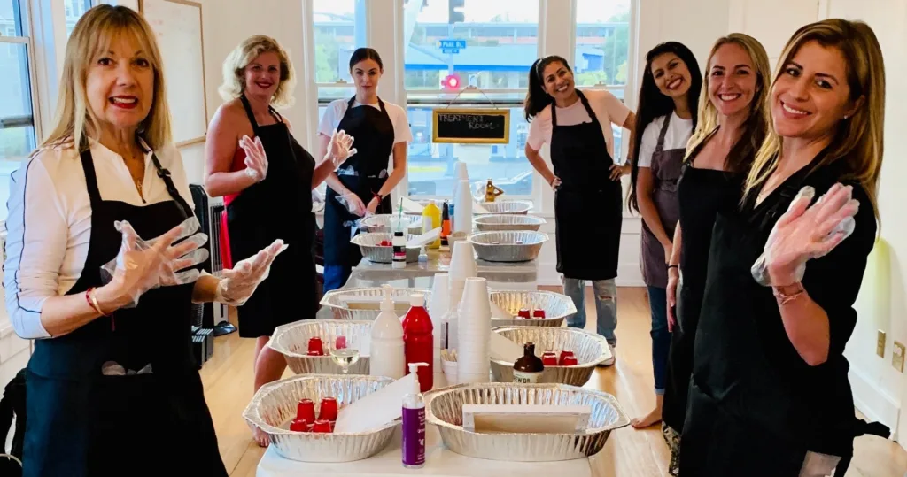 Artist pouring vibrant fluid acrylic paint on canvas