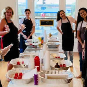 Artist pouring vibrant fluid acrylic paint on canvas