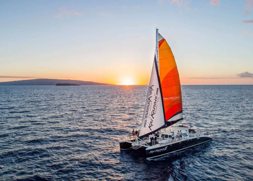 Sailboat gliding during colorful Maui sunset cruise