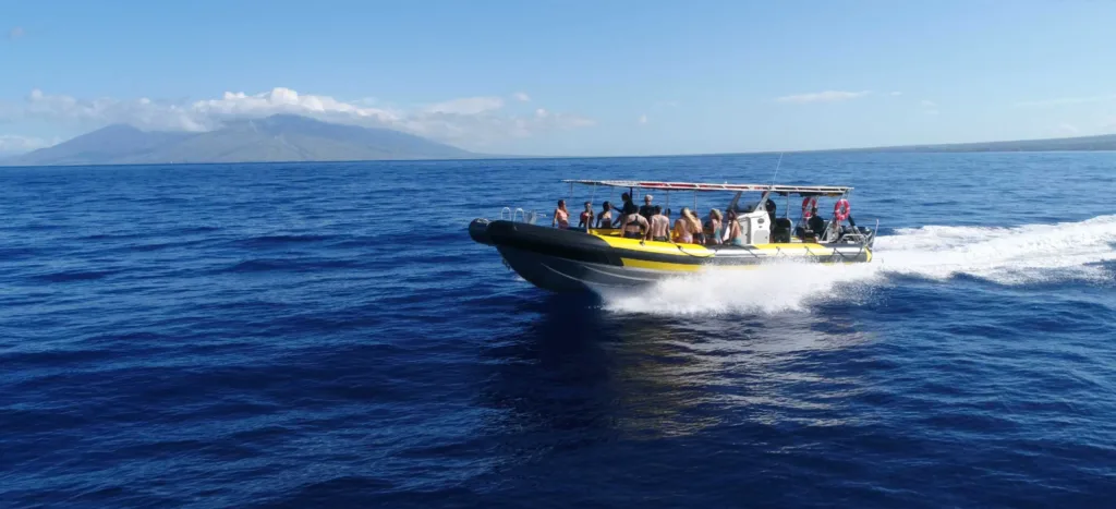 Tour boat anchored near Molokini crater with snorkelers in water