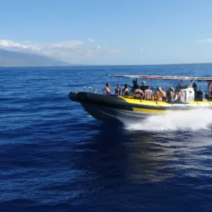 Tour boat anchored near Molokini crater with snorkelers in water