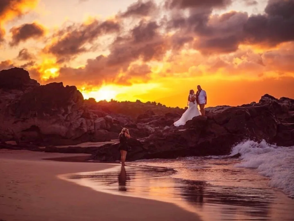 Photographer capturing sunset portraits on Maui beach