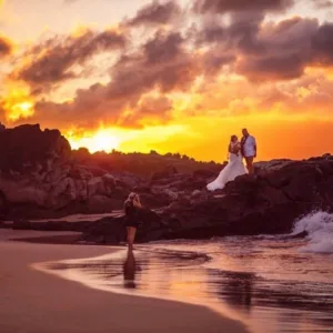 Photographer capturing sunset portraits on Maui beach