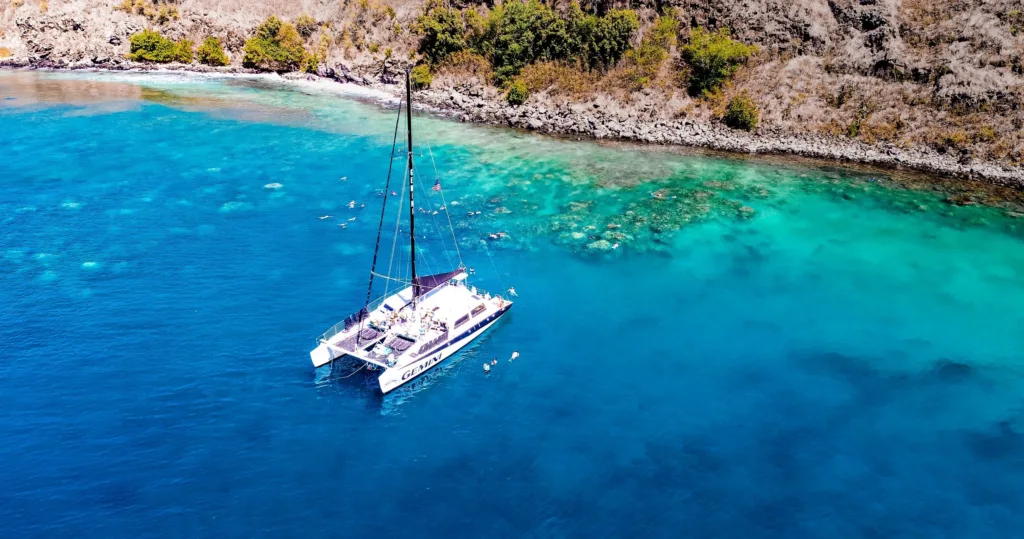 Sailboat gliding through crystal waters on snorkel adventure