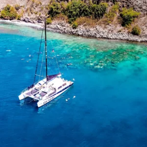 Sailboat gliding through crystal waters on snorkel adventure