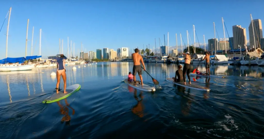 Group enjoying a private stand up paddleboarding lesson together