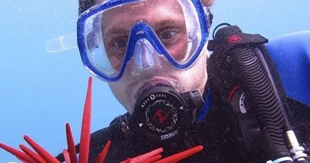 Scuba diver completing open water referral certification in ocean