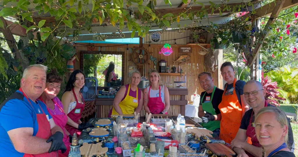 Artist creating ocean-themed resin art with vibrant colors