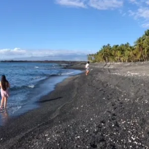 Scenic hike leading to black sand beach with ocean views
