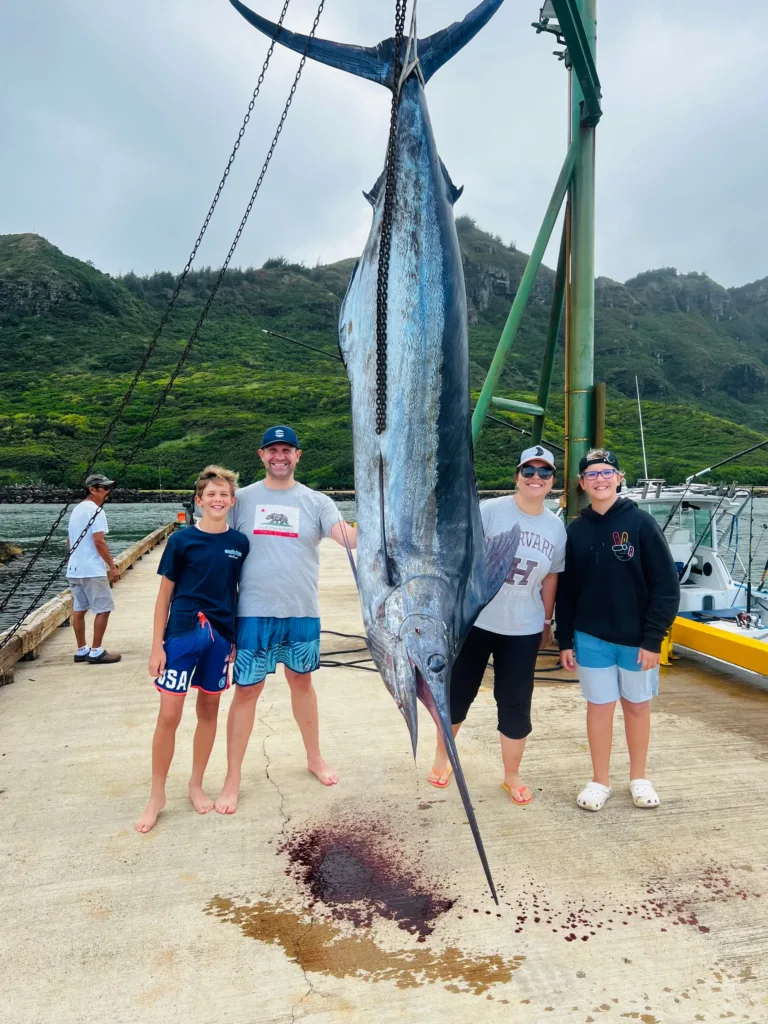 Luxury Bertram yacht cruising Kauai's ocean waters