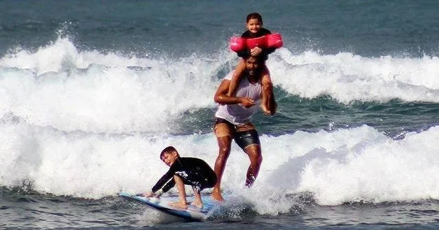 Surf instructor teaching waves on Oahu beach