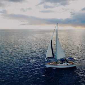 Sailboat gliding through Oahu ocean waters