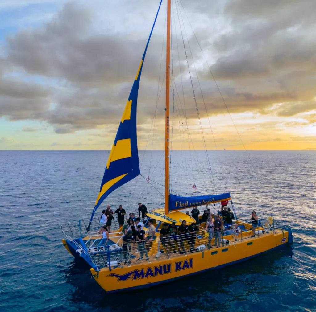 Private sailboat cruising at sunset near Honolulu harbor