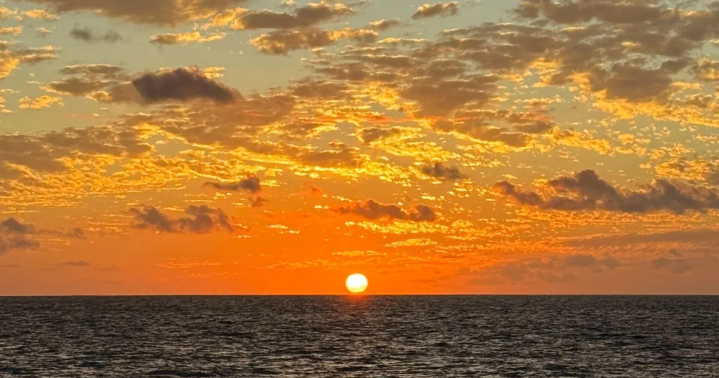 Sunset cruise boat sailing along Kona coastline