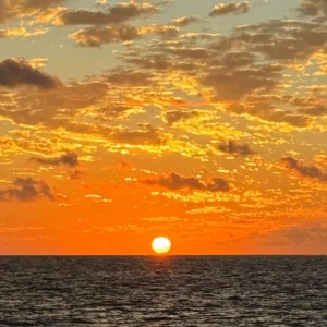 Sunset cruise boat sailing along Kona coastline