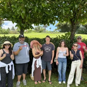 Visitors walking through a lush farm during a guided tour