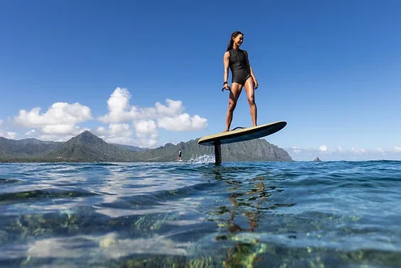 Riding an efoil board over clear tropical waters