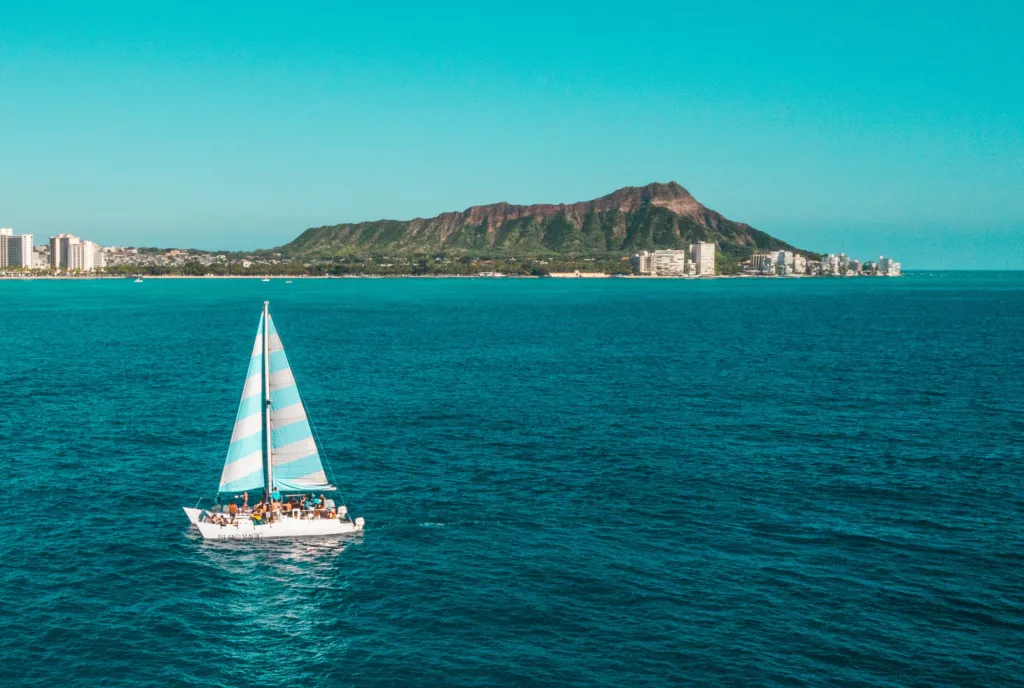 Private charter boat anchored near tropical island shore