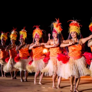 Guests seated in middle section at Hawaiian luau event