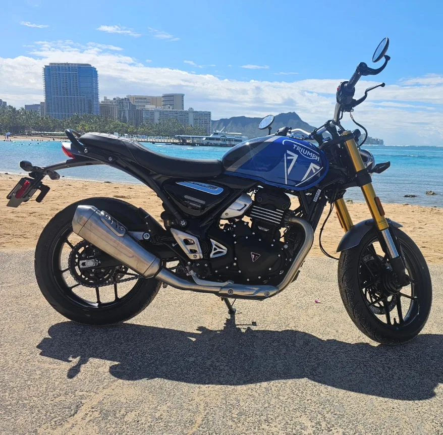 Sleek Triumph Speed 400 motorcycle parked by the ocean