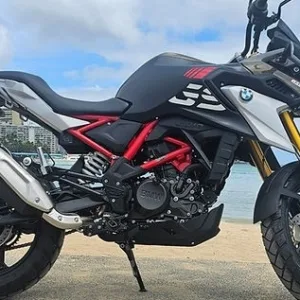 2024 BMW GS 310 parked with ocean backdrop in Waikiki