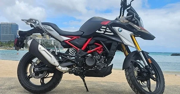 2024 BMW GS 310 parked with ocean backdrop in Waikiki