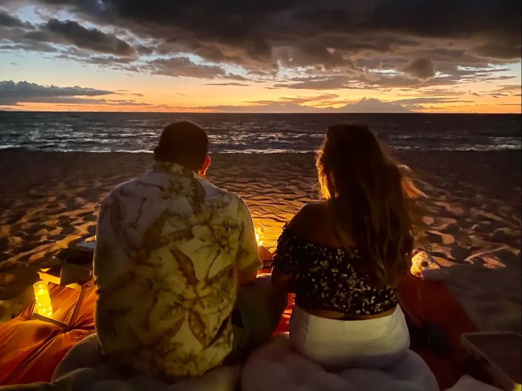 Campfire glowing under starry island night sky