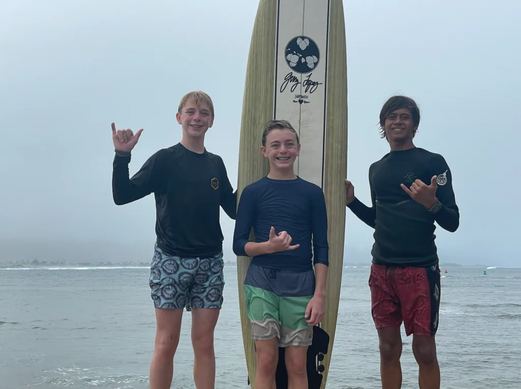 Instructor teaching a small group how to surf on waves