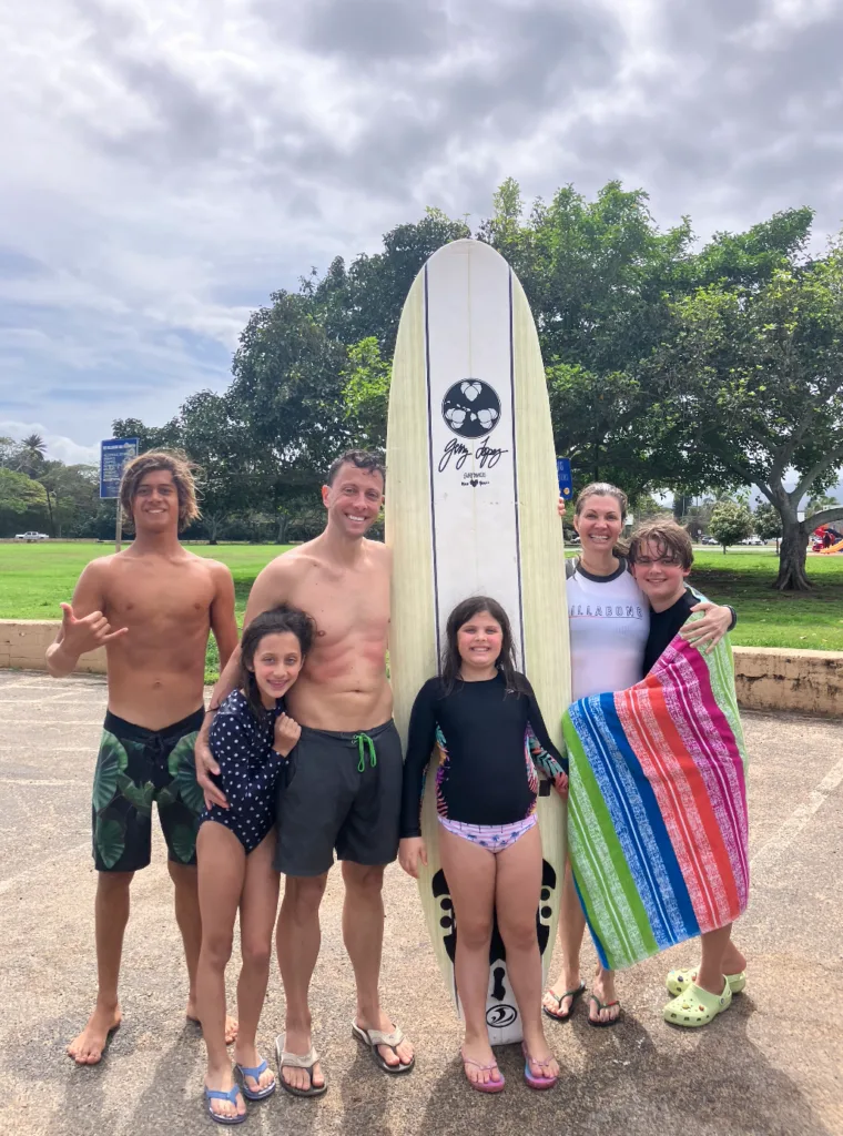 Group enjoying open surf lesson on sunny island beach