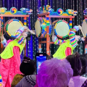 Performers in colorful costumes dancing on stage