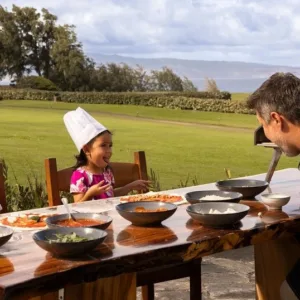 Participants learning to make pizza in Ohana cooking class