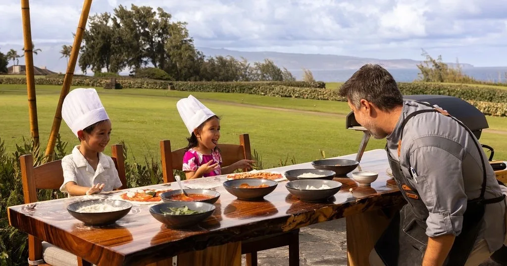 Participants learning to make pizza in Ohana cooking class