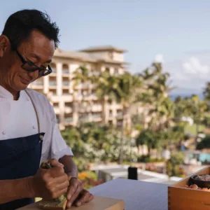Chef guiding participants in sushi making class