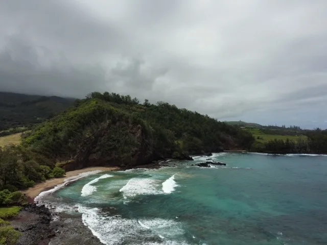 Photographer capturing ocean sunset from a Maui beach