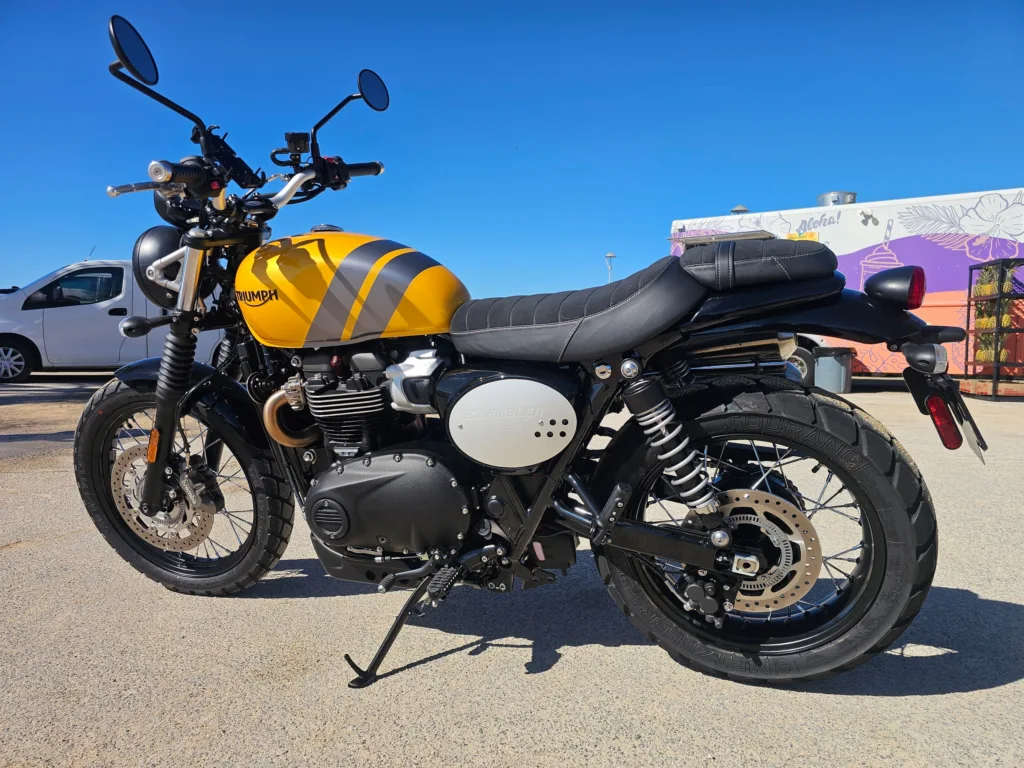 2024 Triumph Scrambler 900 parked on scenic Oahu coastal road