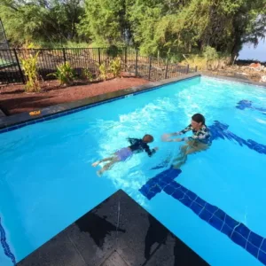 Instructor teaching a swim lesson at a private location