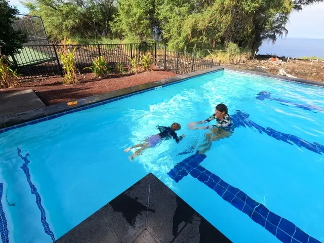 Instructor teaching a swim lesson at a private location