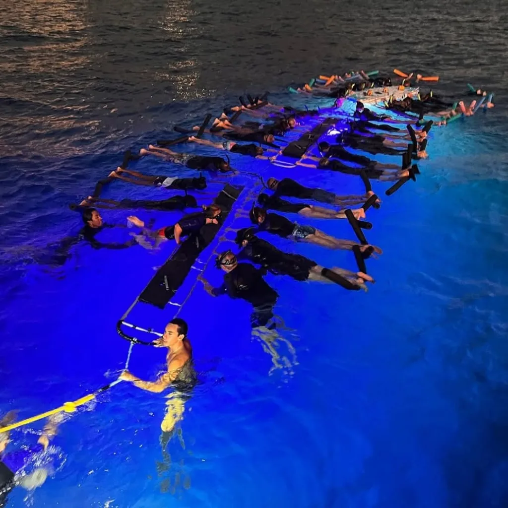 Instructor teaching snorkeling techniques in shallow tropical waters