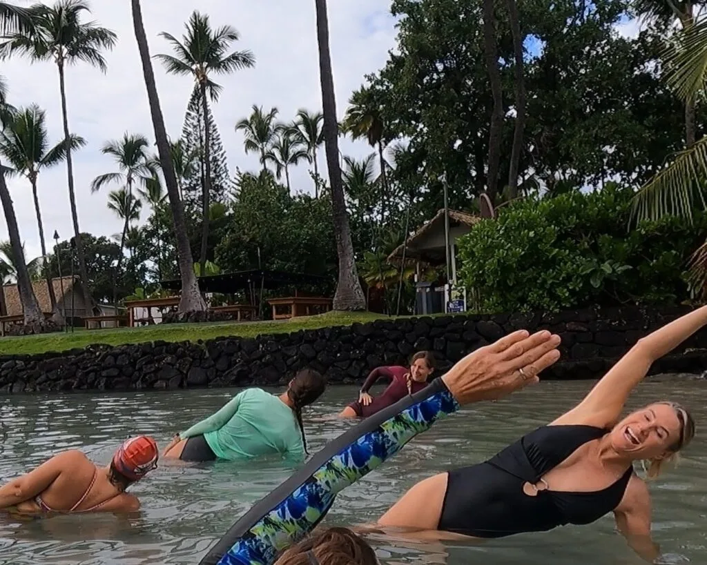 Person practicing yoga on beach with ocean view