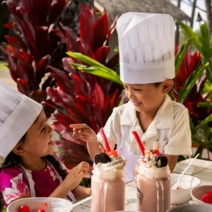 Child learning to make milkshake in fun class
