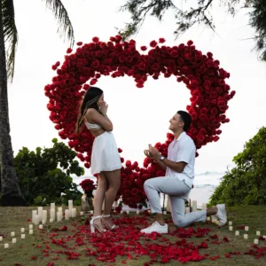 Romantic proposal with giant flower heart at sunset