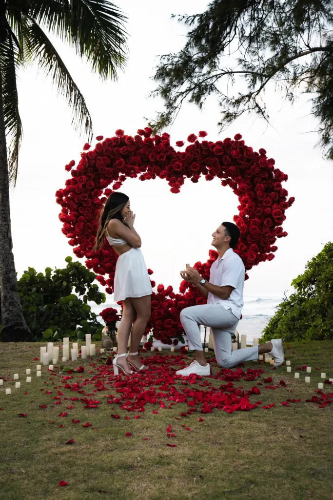 Romantic proposal with giant flower heart at sunset