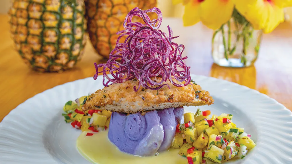 Visitors tasting fresh pineapples on Maui farm tour