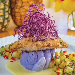 Visitors tasting fresh pineapples on Maui farm tour