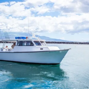 Fishing boat anchored offshore for private bottom fishing trip
