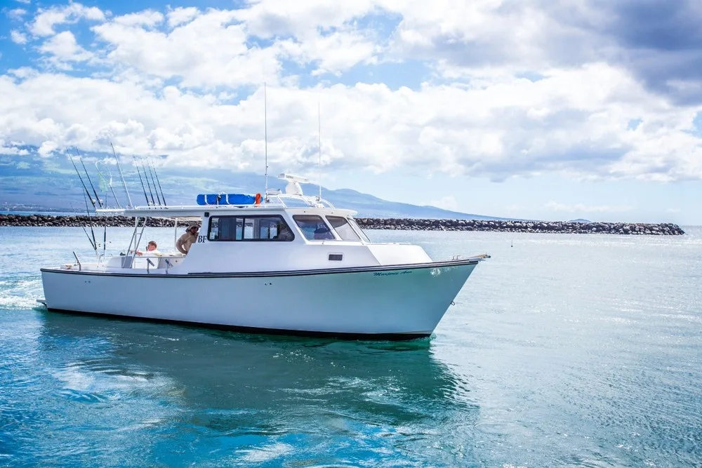 Fishing boat anchored offshore for private bottom fishing trip