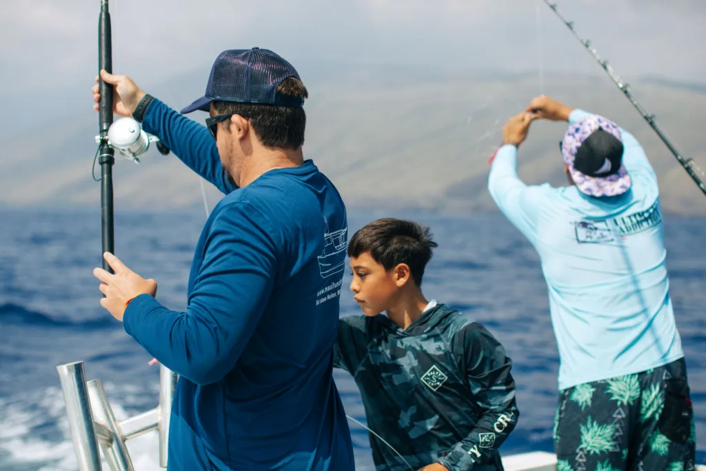 Fisherman casting line during combo fishing and snorkeling trip